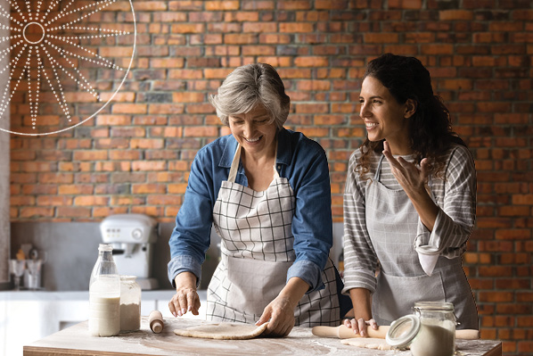two women smiling and baking